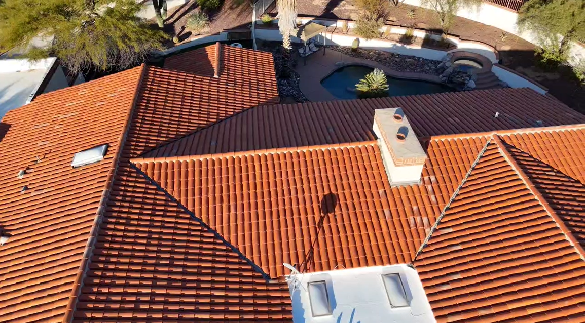 Professional Tucson roof repair crew conducting a monsoon roof inspection to assess storm damage and tile roof condition.