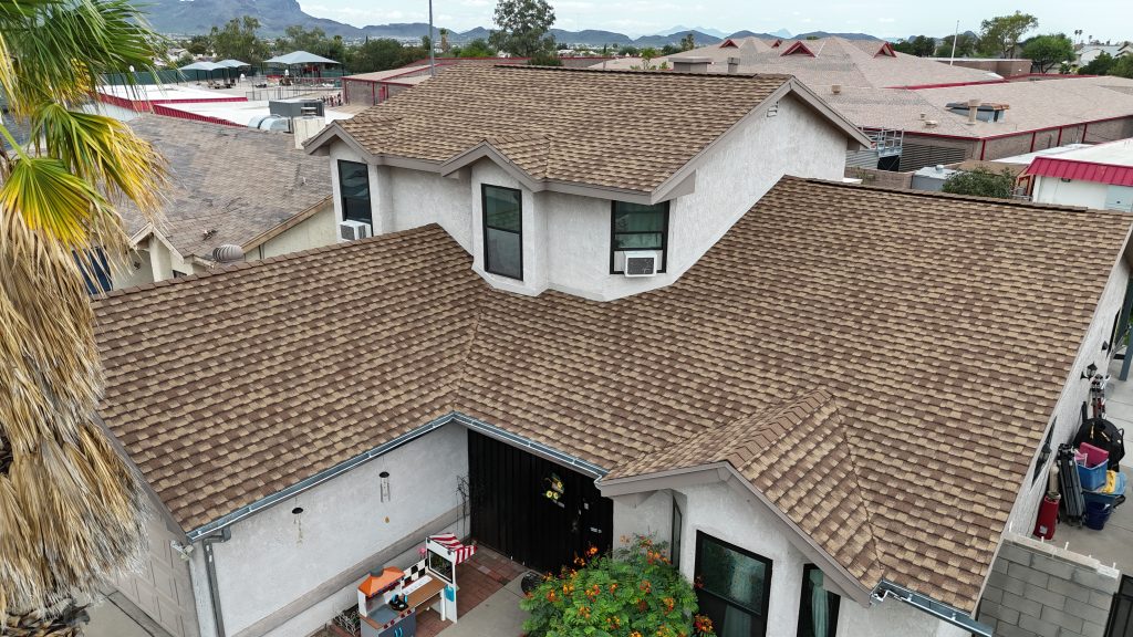 Roof inspector evaluating a Tucson home's shingles during fall prep—key step for homebuyers before closing on a new property.